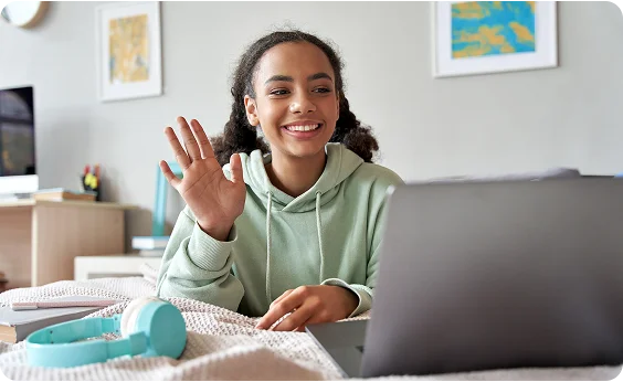 girl saying hi to the computer camera