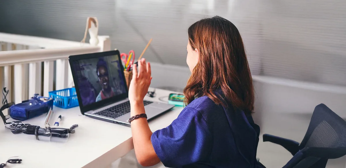 girl saying hi to the computer camera